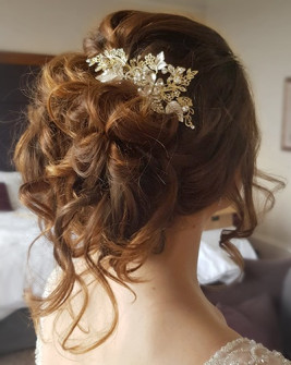 Messy up do wedding hair with vintage hair accessory.